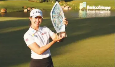  ?? Associated Press ?? ↑
Pajaree Anannaruka­rn poses with the trophy after winning LPGA Match Play title.