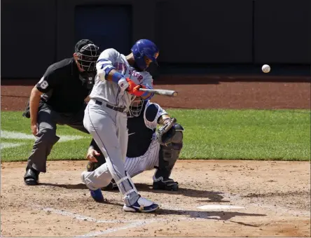  ?? ADAM HUNGER - THE ASSOCIATED PRESS ?? New York Mets’ Robinson Cano hits a two-run home run against the New York Yankees during the fifth inning of the first baseball game of a doublehead­er, Sunday, Aug. 30, 2020, in New York.