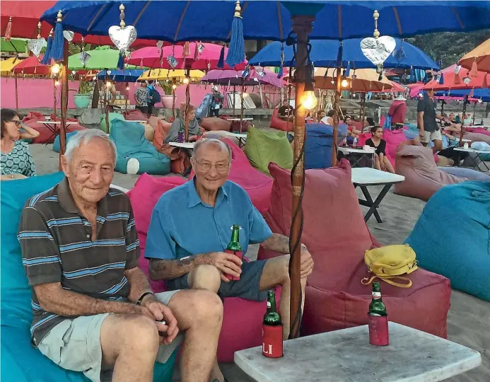  ?? DEBRA NELL ?? Alick, left, and Mac chilling on the beach in Bali with a beer.