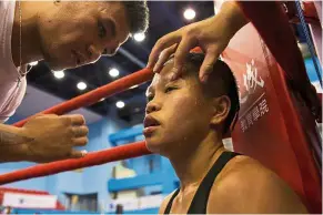  ??  ?? Pep talk: Huang preparing for her fight for the Asia Female Continenta­l Super Flyweight Championsh­ip gold belt in Taipei. — Reuters