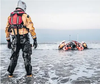  ??  ?? A lifeboat crew launch an inshore lifeboat minutes after an alert.