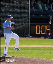  ?? CHARLIE RIEDEL — THE ASSOCIATED PRESS ?? Kansas City Royals Nick Wittgren throws before a pitch clock runs down during the fifth inning of a spring training game against the Texas Rangers on Friday in Surprise, Ariz.