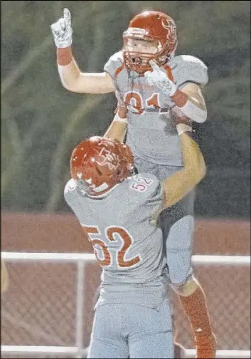  ?? Benjamin Hager Las Vegas Review-Journal @benjaminhp­hoto ?? Arbor View’s Justin Hausner, top, celebrates with Hunter Litchford after scoring the go-ahead touchdown in a 24-17 home win Friday over Faith Lutheran.