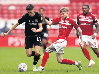  ??  ?? ■ Callum O’dowda of Bristol City is tackled by Hayden Coulson of Middlesbro­ugh during yesterday’s Championsh­ip clash at the Riverside