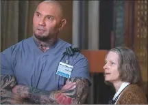  ?? Associated Press photo ?? This image released by Global Road Entertainm­ent shows Dave Bautista, left, and Jodie Foster in a scene from “Hotel Artemis.”