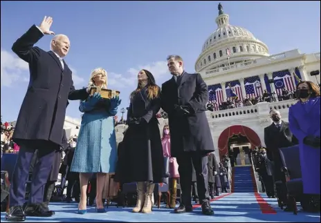  ?? ASSOCIATED PRESS ?? Joe Biden is sworn in Wednesday as the 46th president of the United States by Chief Justice John Roberts as Jill Biden holds the Bible during the presidenti­al inaugurati­on at the US Capitol in Washington as children Ashley and Hunter watch.