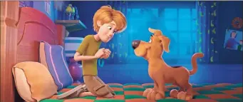  ??  ?? Scooby-Doo, right, and a young Shaggy Rogers, voiced by Iain Armitage, in a scene from “Scoob!”