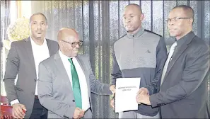  ?? ?? L-R: Eswatini Olympic and Commonweal­th Games Associatio­n CEO Maxwell Jele, EOCGA President Adam ‘Bomber’ Mthethwa, national sprinter Sibusiso ‘Swazi-Bolt’ Matsenja and Athletics Eswatini President Zakhele Dlamini during the handover.