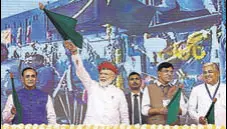  ?? PTI ?? (From left) Gujarat chief minister Vijay Rupani, Prime Minister Narendra Modi and minister of state Mansukh L Mandaviya during a public rally held in Gujarat’s Jamnagar on Monday.