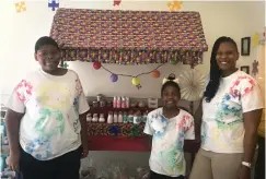  ??  ?? ■ Desiree Soco, right, poses for a photo at her downtown Texarkana shop, Desire’s Sensual Soaps, with Tayton Aldridge and Morgan Aldrige.