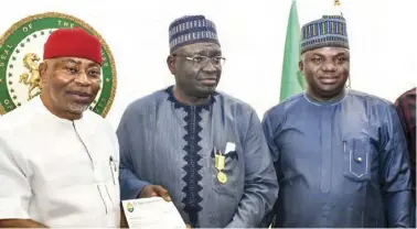  ?? ?? L-R: Deputy Minority leader, House of Representa­tives, Hon. Toby Okechukwu, receiving a letter of award of honourary fellowship of the Nigerian Society of Engineers (NSE) from COREN president, Engr. Rabiu Ali. With them is Hon. Solomon Maren at the National Assembly in Abuja, yesterday. PHOTO BY IBRAHIM MOHAMMED