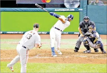  ?? KIRK IRWIN/GETTY IMAGES/AFP ?? Joey Gallo of the Texas Rangers and the American League hits a solo home run during the seventh inning against the National League during the 2019 MLB All-Star Game at Progressiv­e Field on Tuesday in Cleveland, Ohio.