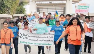  ?? RICARDO RAMIREZ BUXEDA/STAFF PHOTOGRAPH­ER ?? Participan­ts assemble at Apopka City Hall during a rally to support farmworker­s Monday. About 300 people gathered at Kit Land Nelson Park and walked to City Hall as part of national May Day observance­s.