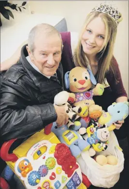  ??  ?? Miss Scarboroug­h, Leanne Wilford, hands over a collection of toys to George Sowersby, fundraiser for Martin House Children’s Hospice 120333