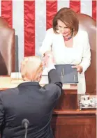  ?? CHIP SOMODEVILL­A/GETTY IMAGES ?? President Donald Trump greets Speaker Nancy Pelosi before the address.