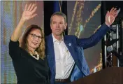  ?? KENNETH FERRIERA — LINCOLN JOURNAL STAR ?? University of Nebraska Regent Jim Pillen, right, and his wife, Suzanne, wave to the crowd of supporters as he is named the winner of the Nebraska Republican gubernator­ial primary during an election night party at the Embassy Suites in Lincoln, Neb., on Tuesday.