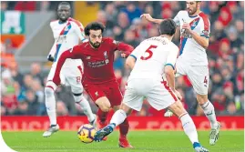  ??  ?? Match-winner Mo Salah skips past the Palace back line