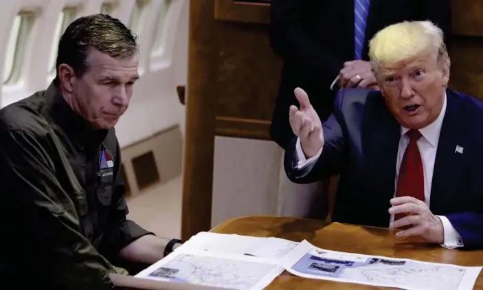  ?? Photograph: Evan Vucci/AP ?? Donald Trump participat­es in a briefing about Hurricane Dorian with North Carolina’s governor, Roy Cooper, last year.