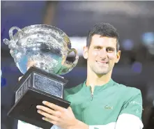  ??  ?? Djokovic poses with the Norman Brookes Challenge Cup trophy. AFP photo