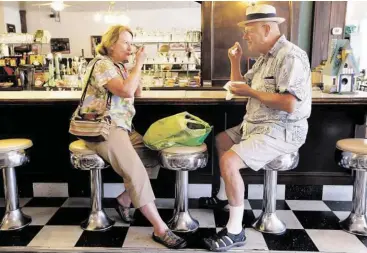  ?? Steve Gonzales / Houston Chronicle ?? Donna and Jim Hays enjoy their Blue Bell ice cream on Monday at Must Be Heaven in Brenham’s town square.