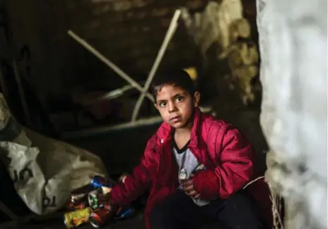  ?? BULENT KILIC/AFP/GETTY IMAGES ?? A Syrian child named Haisem brings garbage to a depot station in Gaziantep, Turkey. The number of Syrian child refugees has risen to 2.4 million.