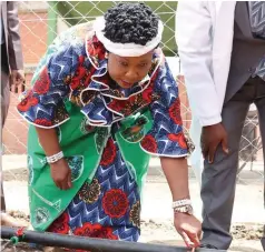  ?? — Pictures: John Manzongo ?? First Lady Dr Auxillia Mnangagwa opens a drip irrigation system in a garden she establishe­d at the skills developmen­t and training centre she launched in Mbare, Harare.