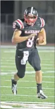  ??  ?? Blackhawk junior Seth Brumley, No. 8, heads down the field carrying the ball in a victorious contest against Greenland.