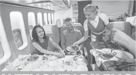  ?? PHOTOS BY DAN MACMEDAN, USA TODAY ?? Stewardess Chandra Brenner serves up the Chateaubri­and in the Clipper Class cabin.