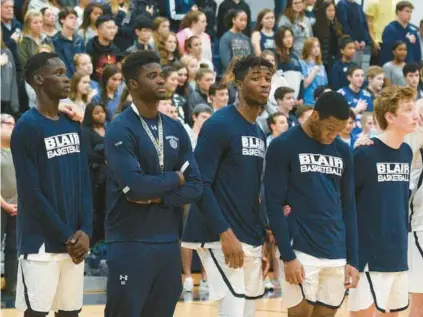  ?? The New COURTESY OF TYSON TRISH/BLAIR ACADEMY ?? David Ojabo, second from left, and Odafe Oweh, third from left, stand on the court together during a Blair Academy basketball game. Jersey basketball standouts became football prospects and are now with the Ravens.