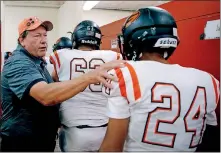  ?? OKLAHOMAN] [SARAH PHIPPS/ THE ?? Guymon coach Kyle Davis talks with players as they leave the locker room before playing Carl Albert on Sept. 27.