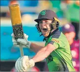  ?? AFP ?? Curtis Campher celebrates after his 72* takes Ireland to a sixwicket win over Scotland in Hobart on Wednesday.