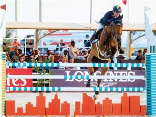  ?? Photo by Neeraj Murali ?? Barcelona, ridden by Penalosa Andres, jumps over hurdles finishing first at the Longines Speed Stakes during the Dubai Horse Jumping Championsh­ip. —