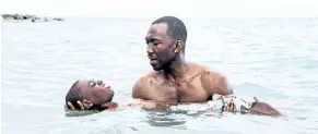  ?? DAVID BORNFRIEND/A24 ?? Alex Hibbert, left, and Mahershala Ali in a scene from the film, Moonlight. The film struck a chord with audiences for its portrayal of a black man’s struggle over his identity.