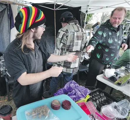  ?? NICK PROCAYLO/PNG ?? David Hill, right, is a partner in a cannabis stand that has been on city-owned property at Renfrew and Hastings streets since the summer, something the neighbours aren’t happy about.