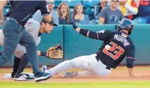  ?? GREG SORBER/JOURNAL ?? Albuquerqu­e’s Tom Murphy (23) slides in with a triple as Salt Lake third baseman David Fletcher awaits the throw on Tuesday night at Isotopes Park.