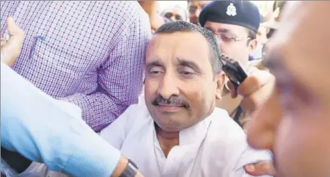  ?? SUBHANKAR CHAKRABORT­Y/HT PHOTO ?? ▪ BJP MLA Kuldeep Singh Sengar reacts after being produced at CBI court in Lucknow, in connection with the Unnao rape case.