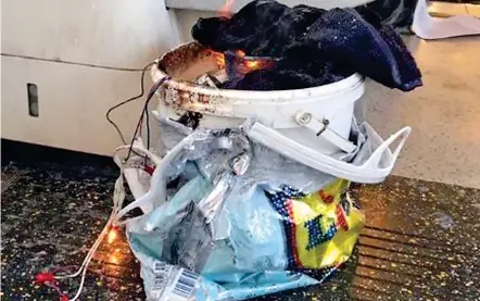  ??  ?? Smoulderin­g: The partially-exploded bucket bomb and the fairy lights used to detonate it yesterday