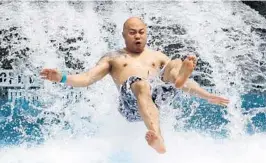  ?? JOE BURBANK/STAFF PHOTOGRAPH­ER ?? A guest catches some air at the splashdown of the Ohyah & Ohno Drop Slides at Universal Orlando’s Volcano Bay water park during a media preview Wednesday.