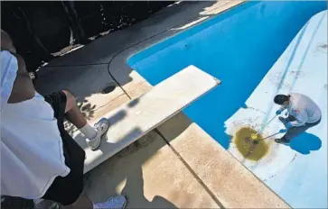  ?? Don Bartletti Los Angeles Times ?? AEDES mosquitoes are capable of transmitti­ng dengue fever, chikunguny­a virus, yellow fever and Zika virus. Above, county vector control inspector Eddie Garcia gets a water sample from a Buena Park pool in 2014.