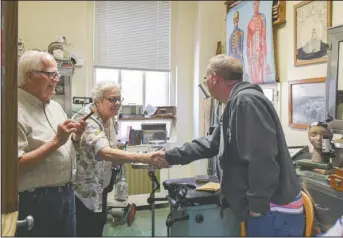  ?? The Sentinel-Record/Grace Brown ?? HISTORICAL TOUR: Clyde Covington, left, and Liz Robbins, the executive director of the Garland County Historical Society, greet Dr. Robbie Jones during a tour of Arkansas Career Training Institute on Wednesday.