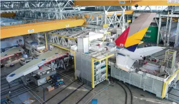  ??  ?? This page: Asiana’s A380 undergoes assemblyLe­ft page: The superjumbo often leaves its spectators in awe