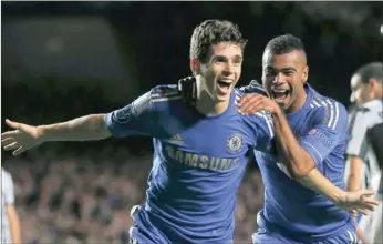  ??  ?? Chelsea’s Oscar, who scored a brace on debut for Champions League title holders Chelsea, celebrates with teammate Ashley Cole netting a goal against Juventus at Stamford Bridge last night.