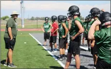  ?? MIKE BUSH/NEWS-SENTINEL ?? Liberty Ranch High football assistant coach Warren Schroeder goes over a drill with players during Monday’s practice on the Hawks’ on-campus stadium, which was completed in the spring.