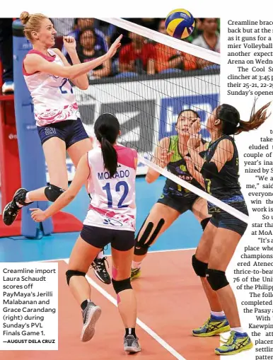  ?? —AUGUST DELA CRUZ ?? Creamline import Laura Schaudt scores off PayMaya’s Jerilli Malabanan and Grace Carandang (right) during Sunday’s PVL Finals Game 1.