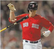  ?? STAFF PHOTO BY STUART CAHILL ?? GETTING OUT OF HAND: Brock Holt flips his bat after making an out in the ninth inning of the Red Sox’ 1-0 loss to the White Sox last night at Fenway.