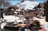  ?? RACHEL DENNY CLOW/CORPUS CHRISTI CALLER-TIMES ?? Above left: More than 9,000 people have gathered at the downtown evacuation center at the George R. Brown Convention Center on Tuesday in Houston, Texas. Above right: Lance Esswein digs through the rubble of his wife’s antique and resale shop, Brand...