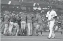  ?? AP ?? The Rockies’ Matt Holliday walks off the field as the Brewers celebrate winning their NL Division Series.