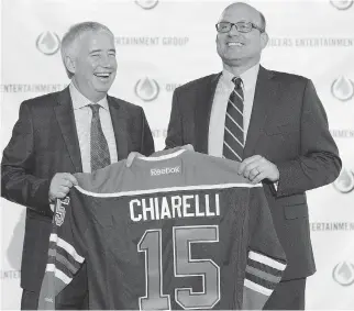  ?? JASON FRANSON/THE CANADIAN PRESS ?? Edmonton Oilers CEO Bob Nicholson, left, and new president and general manager Peter Chiarelli during a news conference in Edmonton on Friday. The Oilers play fast, but not hard, and Chiarelli wants to instill a ‘heavier’ style of play, Cam Cole writes.