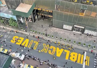  ??  ?? EVERYONE’S A CRITIC: Volunteers on Thursday paint a giant Black Lives Matter mural on Fifth Avenue in front of Trump Tower — attracting some complaints from passersby.and nasty digs at the mayor.