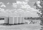  ?? [PHOTO PROVIDED] ?? Storage tanks collect oil from a Devon Energy Corp. well in Blaine County.